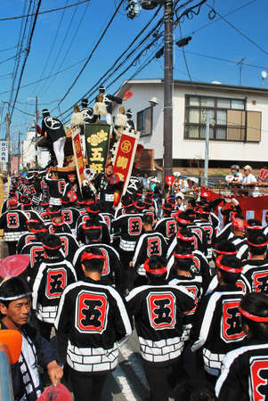 JAPAN - SEP 13: Annual Danjiri festival held on Sept 13, 2008 in Kishiwada ward, Osaka, Japan. In this event, huge wooden floats are carried by a team of male participants and used in races against other teams.のeditorial素材