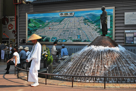 Taken at a clearing outside Nara station on the Kentetsu line in Japan. A monk stands at the fountain asking for alms.のeditorial素材