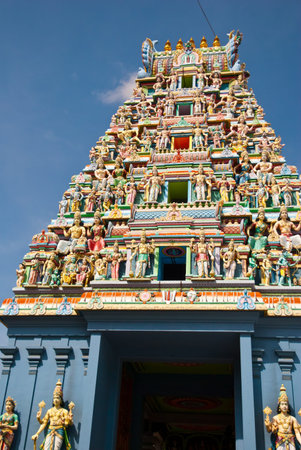 Majestic front entrance of Sri Mariamman temple with colorful carvings on its roof.の写真素材