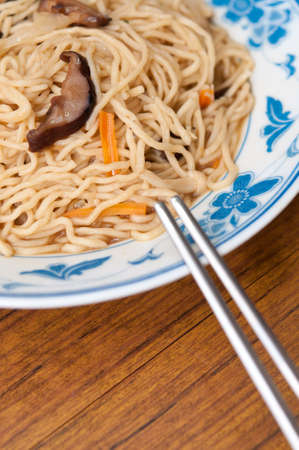 Simple dish of Chinese style white noodles and chopsticks.の写真素材