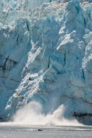 Closeup shot of majestic calving of huge ice glacier into the sea.の写真素材