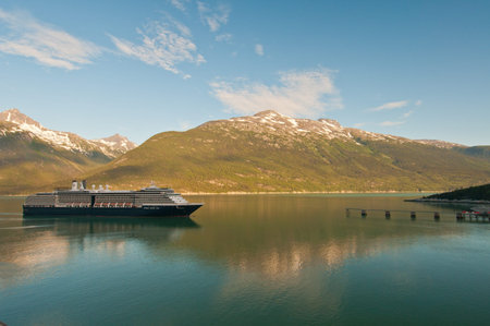 Cruise ship reaching and sailing into detination port with beautiful mountains.の写真素材