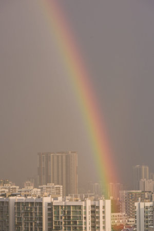 Closeup of rainbow over residential apartments in Singapore.の写真素材