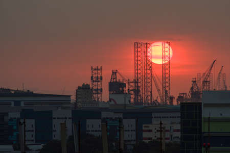 Closeup of beautiful red setting sun over industrial area. Taken 08 January 2016.のeditorial素材