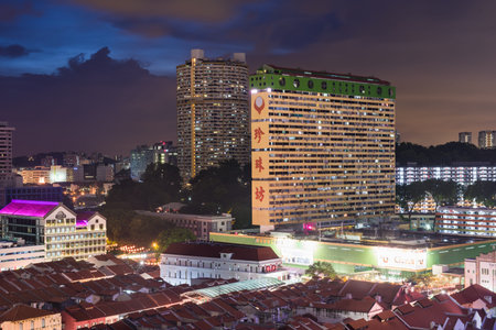 Night view of old buildings of Chinatown with shophouses in foreground. Taken 05 February 2016.