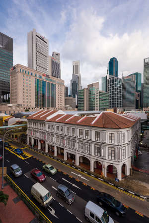 Singapore, 05 Feb 2016: Historical buildings and skyscrapers along a busy street in Singapore.のeditorial素材