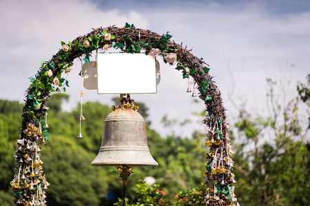 Old wedding bell with pretty flower decoration.の写真素材