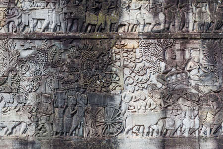 Stone carvings on walls depicting life of the past era at Angkor Thom.の写真素材