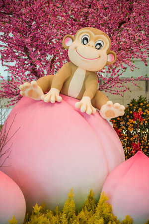 Singapore, 11 Feb 2016: Monkey mascot sitting on longevity peach as part of Chinese Lunar New Year...