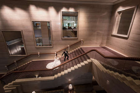 Singapore, 09 Jan 2016: Portrait of wedding couple at gorgeous Sheraton Towers Hotel on their wedding day.This favourite image of mine was a really quick portrait after the couple's first march-in and just before they made their way back to their suite のeditorial素材