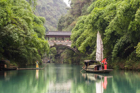 Chongqing, China, 18 Nov 2012: Chinese lady and musician along scenic river in Three Gorges.のeditorial素材