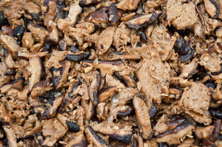 Closeup shot of black mushrooms with seasoned vegetarian mutton meat.