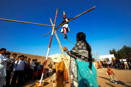 JAISALMER, INDIA - FEB 24   an unidentified girl performs an acrobat on Feb 24, 2013 in Jaisalmer, India   The event is part of the Desert Festival held in winter to attract both domestic and international tourists のeditorial素材