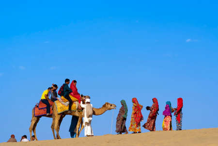JAISALMER, INDIA - FEB 25   Camel riding at the Sam Sand Dune on Feb 25, 2013 in Jaisalmer, India   The activity is part of the Desert Festival held in winter to attract both domestic and international tourists のeditorial素材
