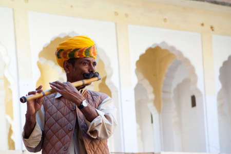 JODHPUR, INDIA - FEB 28  a musician plays a flute at the Mehrangarh Fort on Februay 28, 2013 in Jodhpur, India  Mehrangarh Fort is one of the most important and must-visit attractions in Jodhpur のeditorial素材
