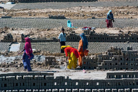 UTTAR PRADESH, INDIA- MAR 2  labourers prepare bricks at a brick kiln on March 2, 2013, in Uttar Pradesh, India  The Indian brick industry is the second largest in the world after China のeditorial素材