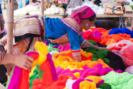 BAC HA MARKET, VIETNAM - JULY 5: A hill tribal woman looks for her goods on July 5, 2009 in Lao Cai, Vietnam. This is the biggest ethnic market in Lao Cai for the exchange of goods and socializing among the ethnic minorities.のeditorial素材