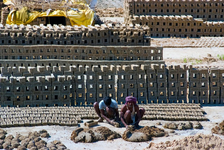 UTTAR PRADESH, INDIA- MAR 2  labourers prepare bricks at a brick kiln on March 2, 2013, in Uttar...