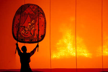 RATCHBURI, THAILAND - APRIL 13  Large Shadow Play is performed at Wat Khanon on April 13, 2013  The ancient performing art involves manipulating puppets of cowhide in front of a backlit screen with musical and narrative accompanimentのeditorial素材