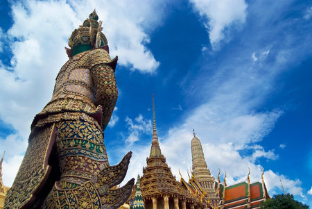 The statue of mythical guardian at the Temple of Emerald Buddha overlooking the temple's compound