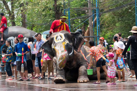 AYUTTHAYA, THAILAND - APR 13:  Revelers and elephants join in water splashing during Songkran Festival on Apr 13, 2014 in Ayutthaya, Thailand.  The water festival has long been observed as New Year for Thai people.のeditorial素材