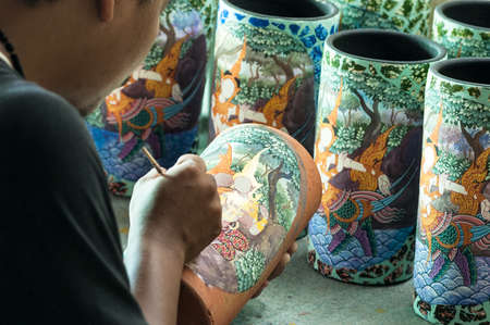 SUPHANBURI, THAILAND - AUG 18: a vase being painted with Thai style  on Aug 18, 2007 in Suphanburi, Thailand and can be used for many purposes i.e. household decoration.のeditorial素材