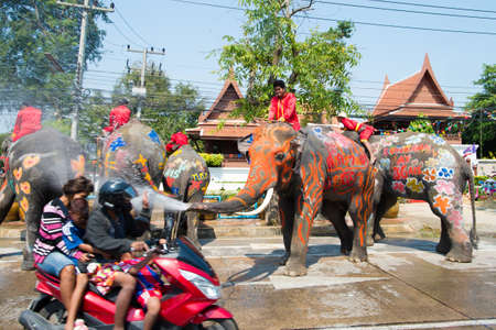 AYUTTHAYA, THAILAND - APR 14:  Revelers enjoy water splashing with elephants during Songkran Festival on Apr 14, 2015 in Ayutthaya, Thailand.  Water splashing is the way Thai people celebrate New Year.のeditorial素材