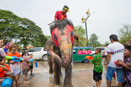 AYUTTHAYA, THAILAND - APR 13:  Revelers and elephants join in water splashing during Songkran Festival on Apr 13, 2015 in Ayutthaya, Thailand.  The festival is a national celebration of the Thai New Yearのeditorial素材