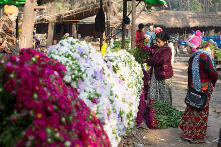 MANDALAY, MYANMAR - FEB 2, 2016: Vibrant morning market on the roadside to Mandalay on Feb 2, 2016.  Flowers are principally used in Myanmar as offerings to Buddha, both in homes and temples.のeditorial素材