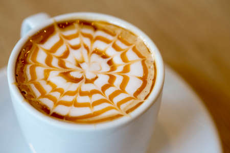 A cup of hot caramel macchiatoの写真素材