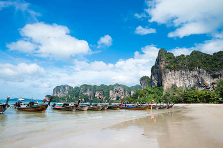 KRABI, THAILAND â DEC 5, 2015: long-tailed boats for tourists are docked along the Railay Beach which is one of the most strikingly beautiful beaches in Thailandのeditorial素材