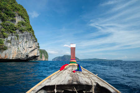 Long-tailed boat heading to the sea shoreの写真素材