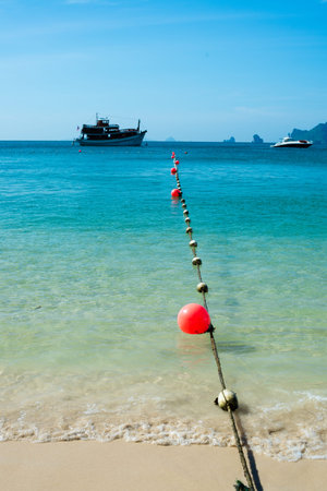 String of marker buoys is anchored on the beachの写真素材