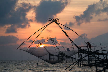 Labour-intensive fishing technique by using giant nets in the south of Thailand. The net is descended into the water for a short time and then raised by pulling on the ropesの写真素材