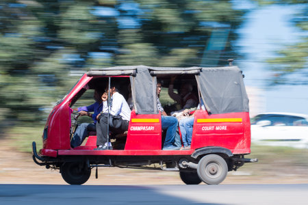 SILIGURI, INDIA â DECEMBER 5, 2016: people travelling on an electric rickshaw along the road of Siliguri.のeditorial素材