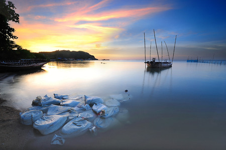 Wreak ship in the sea with the sunset timeの写真素材