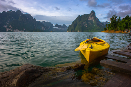 Yellow boat with the raft house on the lake sceneの写真素材