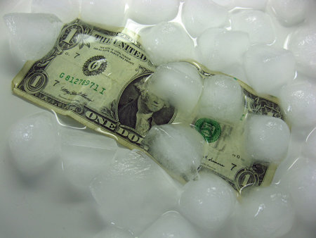 wet crumpled dollar bill under melting ice. The background is white. Lots of water.の写真素材