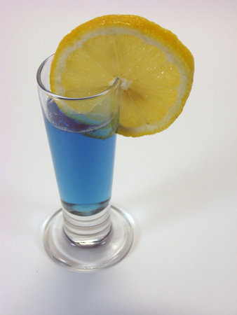 bright blue drink in small shot type glassの写真素材