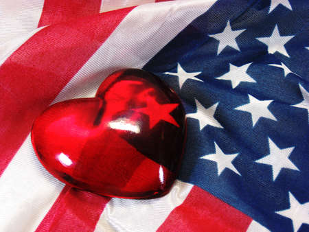 glass heart on American USA flag red white and blueの写真素材