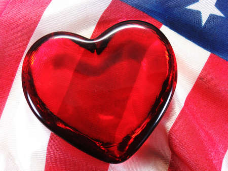 glass heart on American USA flag red white and blueの写真素材