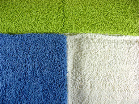 different colored washcloths face cloths on yellow backgroundの写真素材