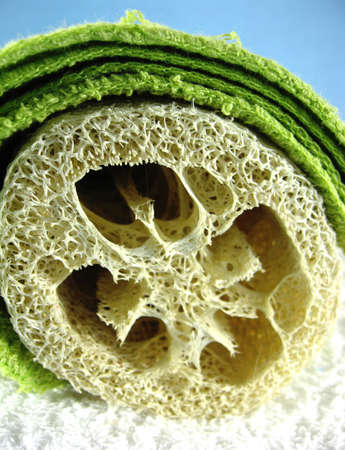 different colored washcloths face cloths and loofah の写真素材