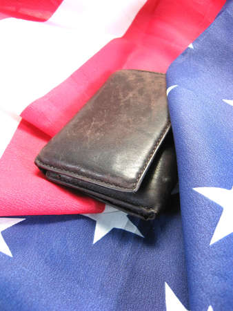 american flag with cash linking patriotism with finiancial interestsの写真素材
