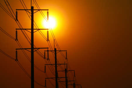 The shadow of the electric pole in the background of the sun.の写真素材