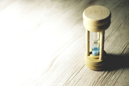 hourglass on the table with wasted time. time management.の写真素材