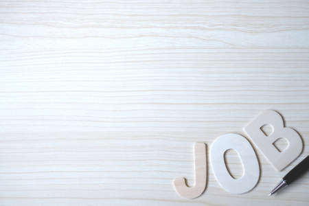 The word JOB, Wooden letters on a wooden table. Top view.の写真素材