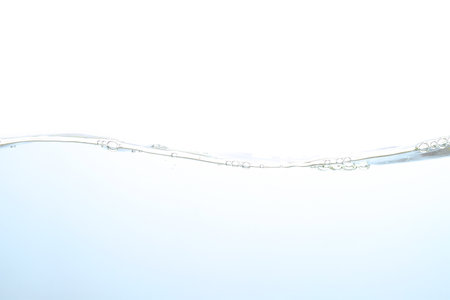 The surface of the water. White background. Movement. Close-up view.の写真素材