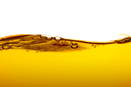 orange juice is isolated on white background. healthy fresh drink and natural waves. close up view.の写真素材