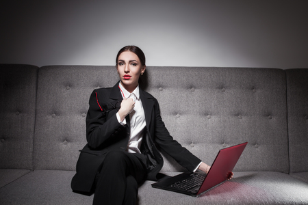 businesswoman dressed in suit and with laptop;の写真素材